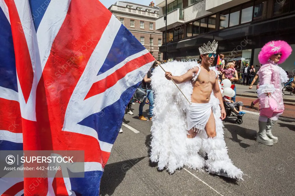 Participant holding union jack in the Annual Gay Pride Parade, London, England