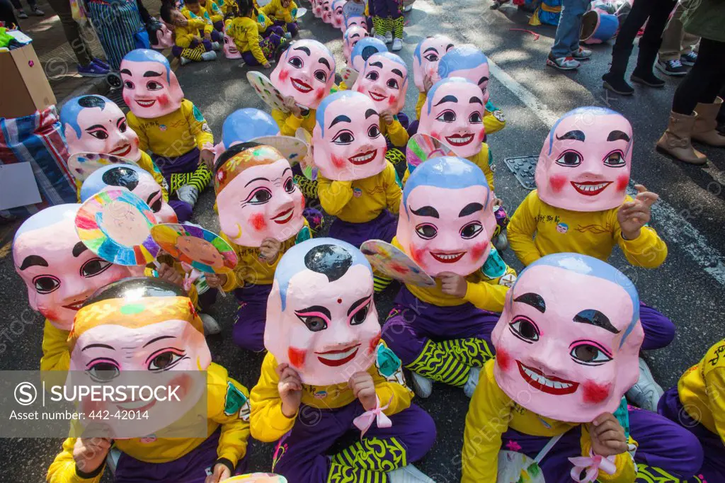 China, Hong Kong, Annual New Years Day Festival Parade, Children Dressed in Happy Buddha Masks