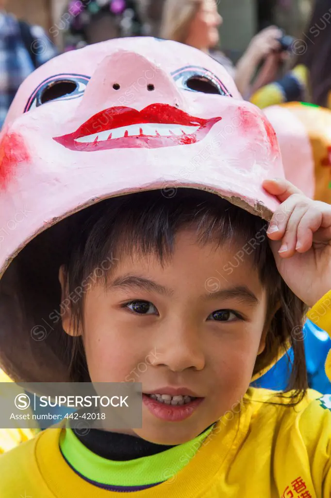 China, Hong Kong, Annual New Years Day Festival Parade, Child with Happy Buddha Mask