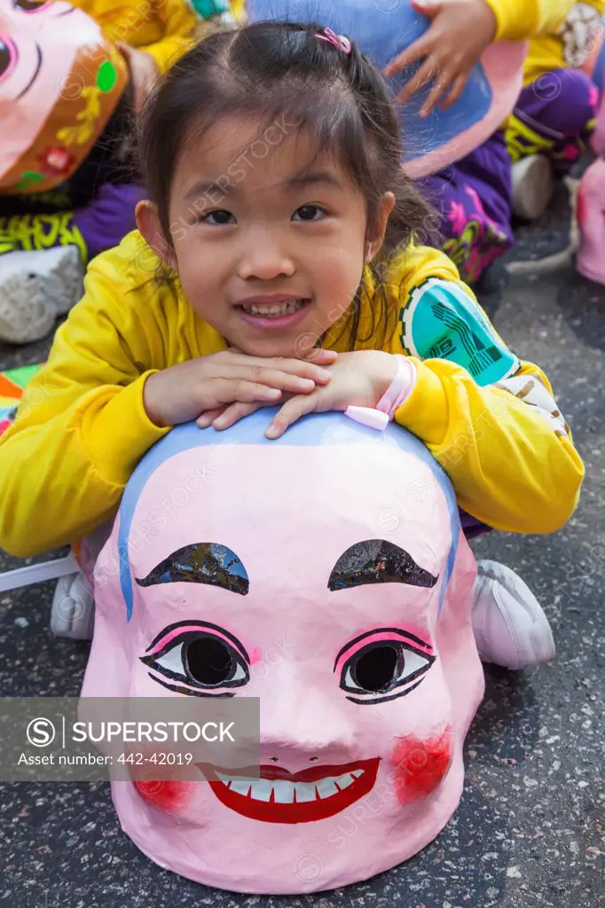 China, Hong Kong, Annual New Years Day Festival Parade, Child with Happy Buddha Mask