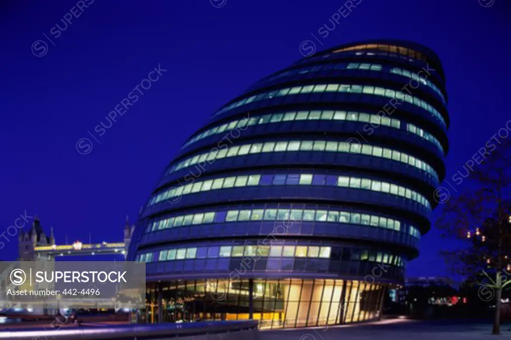 Low angle view of a building illuminated at night, City Hall, London, England