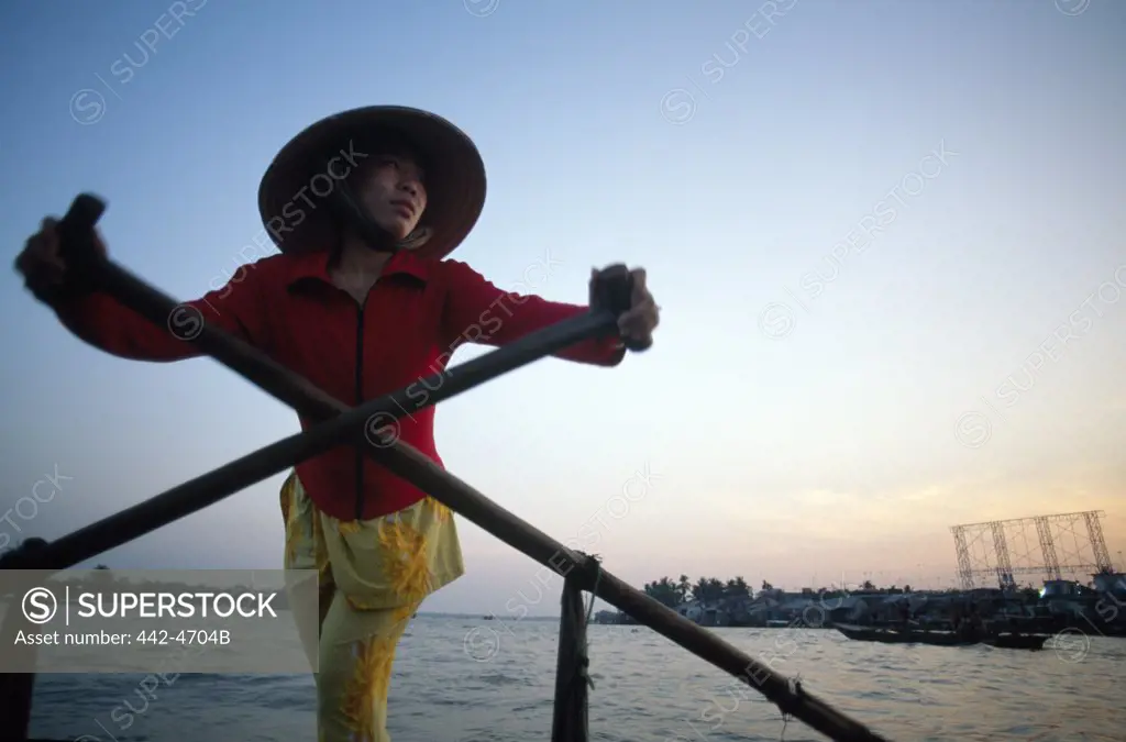 Young woman rowing a boat, Mekong River, Can Tho, Vietnam