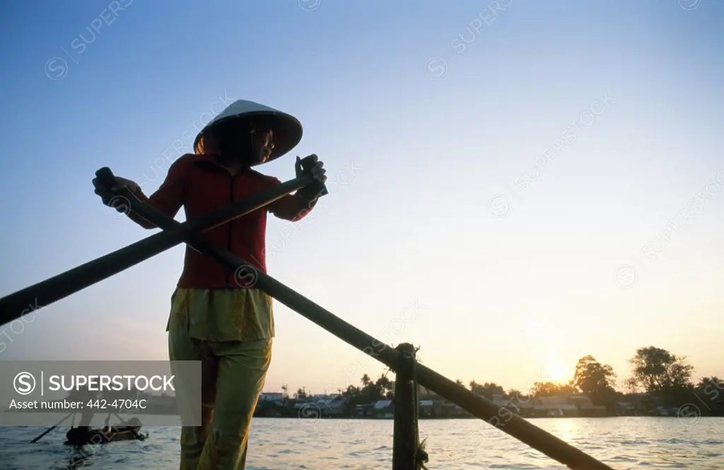 Young woman rowing a boat, Mekong River, Can Tho, Vietnam