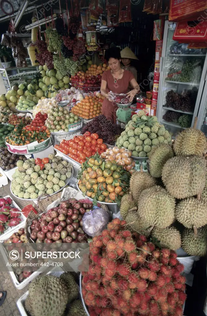 Mid adult woman selling fruits and vegetables, Can Tho, Vietnam