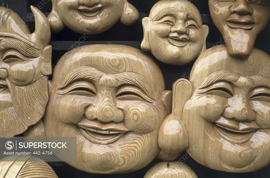 Close-up of faces of laughing Buddha, Vietnam