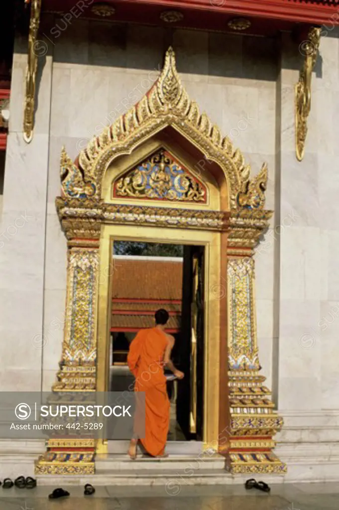 Rear view of a monk entering a temple, Wat Benchamabophit, Bangkok, Thailand