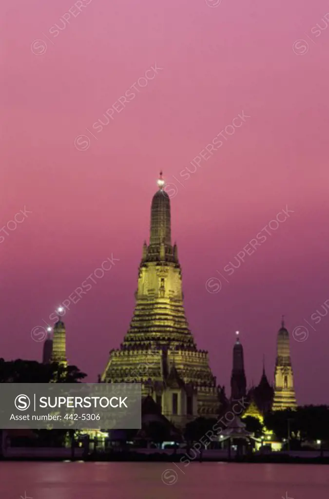Buddhist temple lit up at night, Wat Arun, Bangkok, Thailand