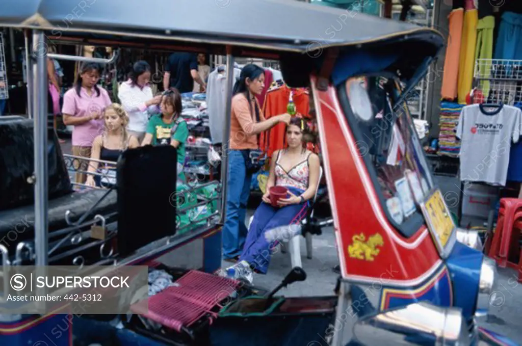 Hairdressers setting tourists' hair, Bangkok, Thailand