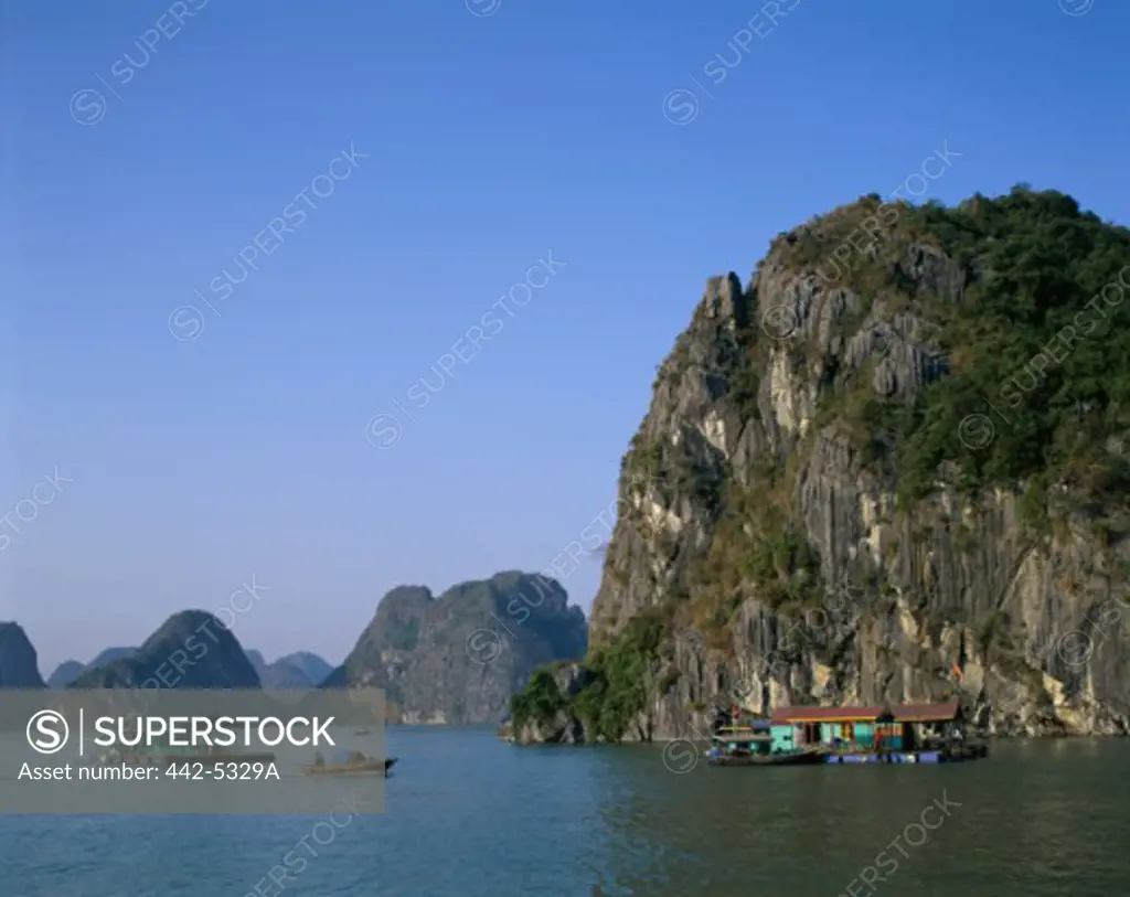 Person rowing a boat in the river, Ha Long Bay, Vietnam
