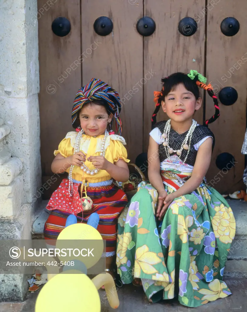 Portrait of two girls wearing traditional clothing, Oaxaca, Mexico