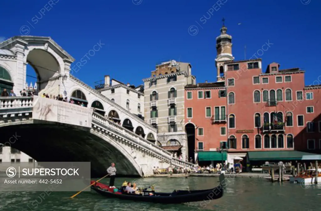 Tourists on a gondola, Rialto Bridge, Venice, Italy