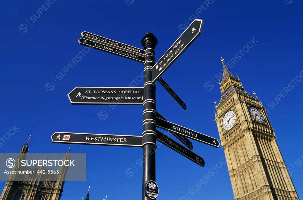 Low angle view of a sign post, Big Ben, London, England