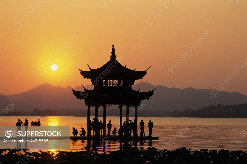 Silhouette of a pagoda in West Lake during sunset, Hangzhou, China