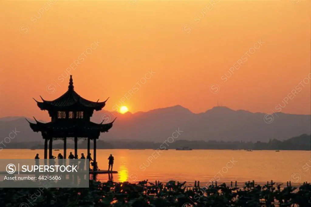 Silhouette of a pagoda in West Lake during sunset, Hangzhou, China