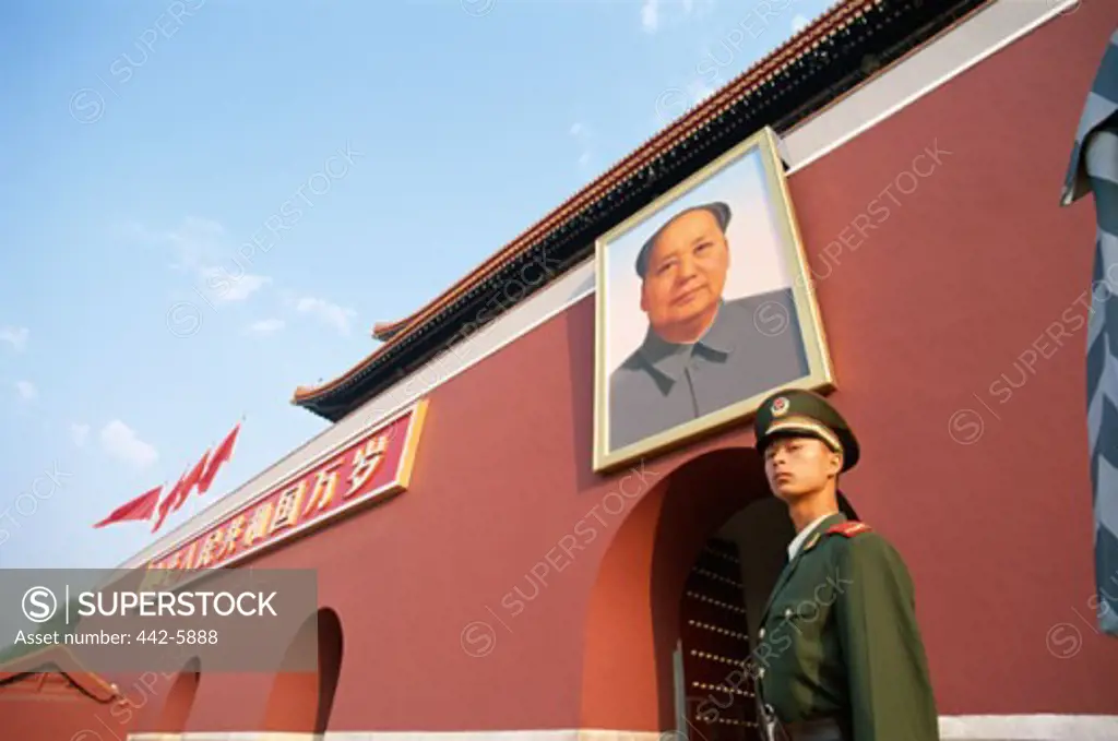 Low angle view of a guard standing under a Mao Zedong portrait, Tiananmen Gate, Tiananmen Square, Beijing, China