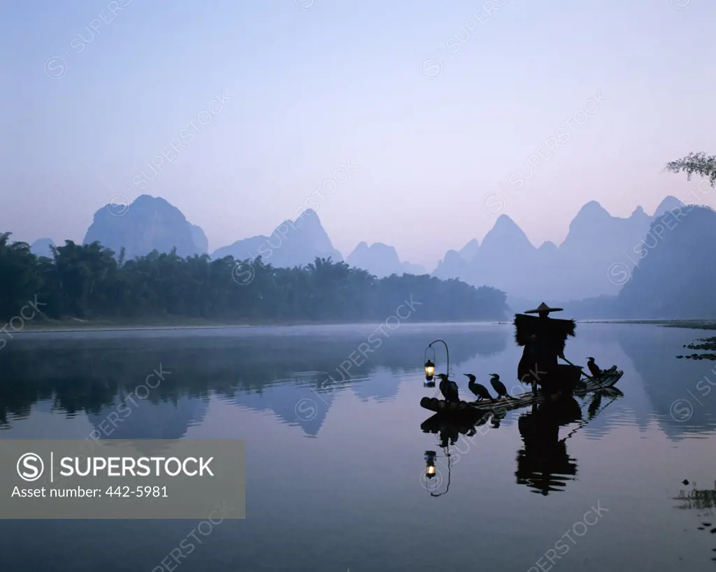 Cormorant fisherman on a raft on the Li River, Guilin, Yangshou, China