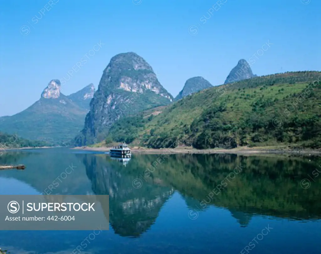 Limestone mountains with a boat in the Li River, Guilin, Yangshou, China