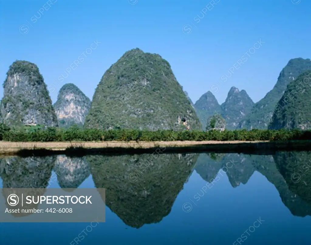 Reflection of limestone mountains in a river, Li River, Guilin, Yangshou, China