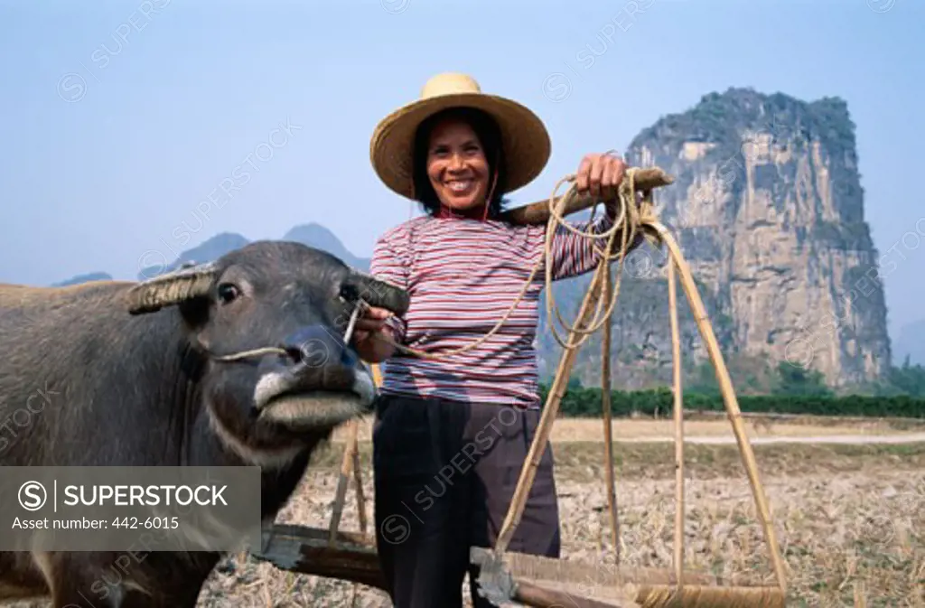 Portrait of a female farmer with a water buffalo, Guilin, Yangshou, China