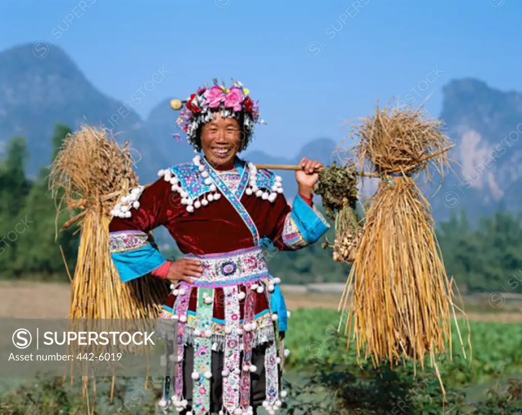 Female farmer dressed in an ethnic costume, Guilin, Yangshou, China