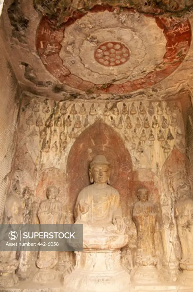 Low angle view of a Buddha statue, Longmen Buddhist Caves, Luoyang, China