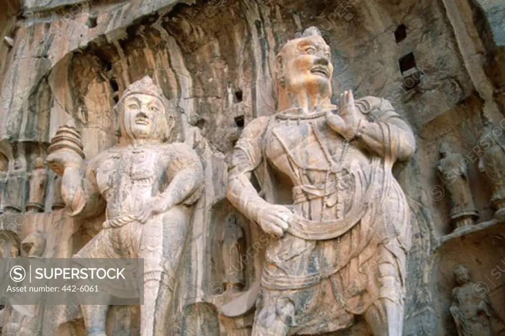 Low angle view of statues, Bodhisattva and Guardian Statues, Ancestor Worshipping Temple, Longmen Buddhist Caves, Luoyang, China