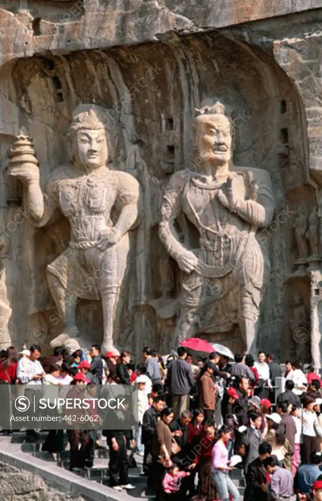 Tourists at carvings, Longmen Buddhist Caves, Luoyang, China