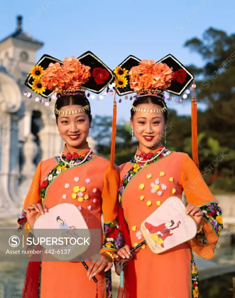 Portrait of two young women dressed in traditional costumes, Beijing, China