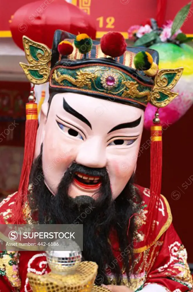 Person wearing a Chinese Lucky God Mask, God of Wealth, Shanghai, China