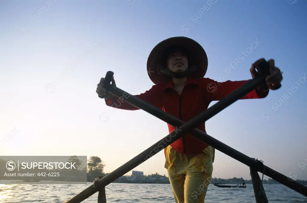 Young woman standing on a boat, Mekong River, Can Tho, Vietnam
