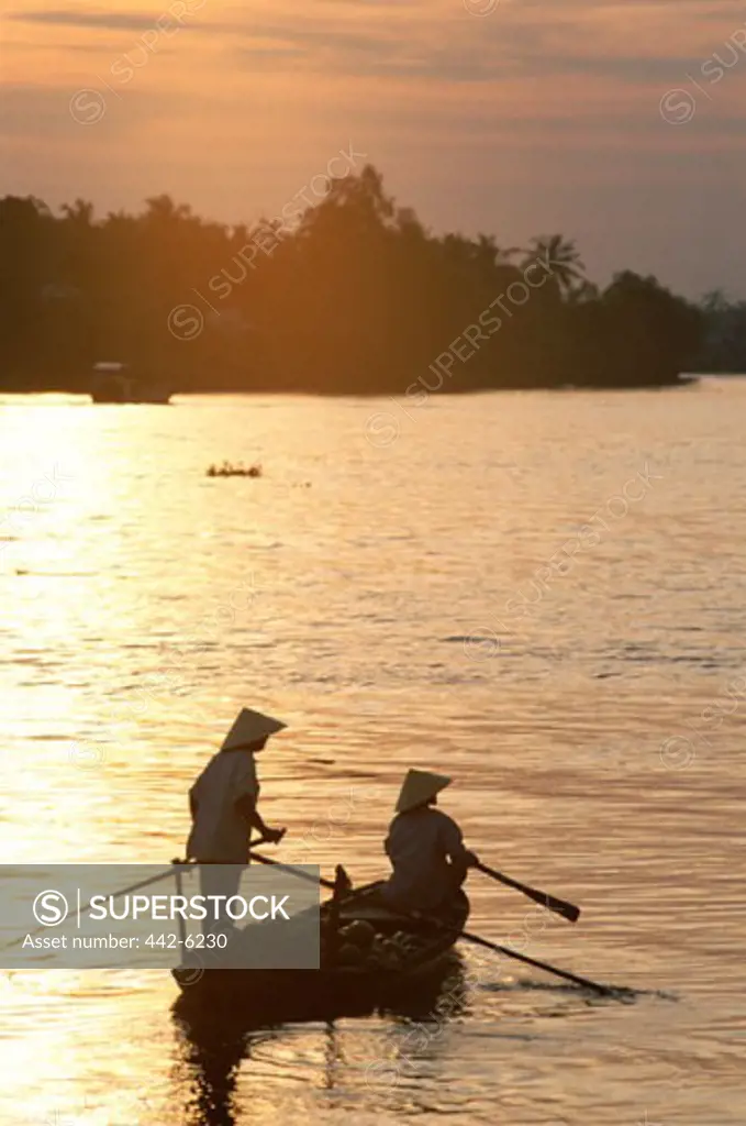 High angle view of two fishermen rowing a boat, Mekong River, Can Tho, Vietnam