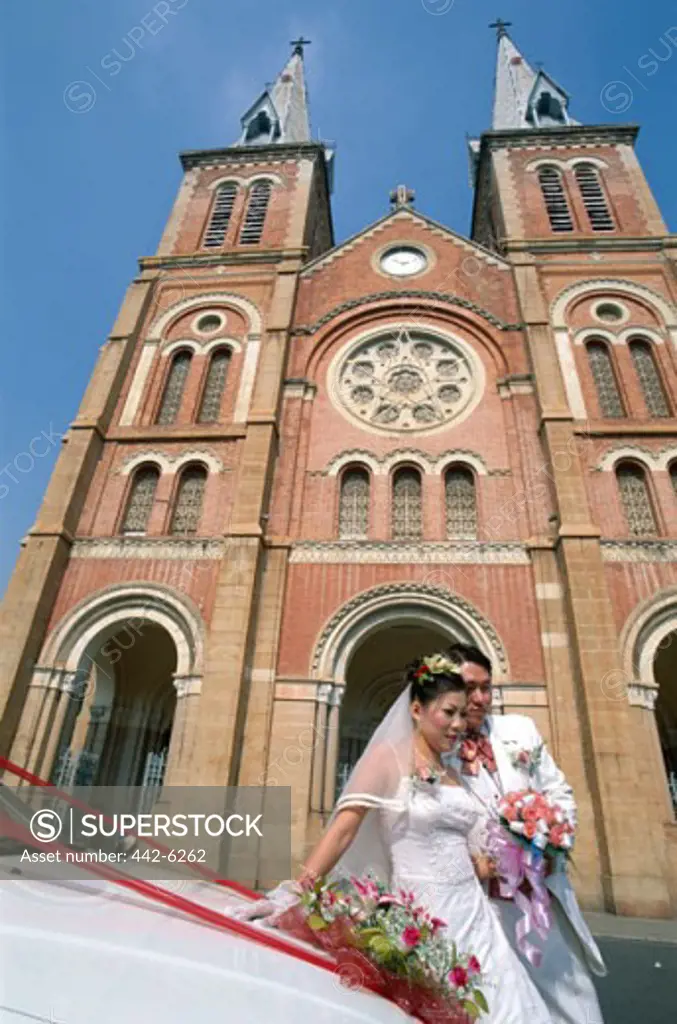 Newlywed couple in front of a cathedral, Notre Dame Cathedral, Ho Chi Minh City, Vietnam