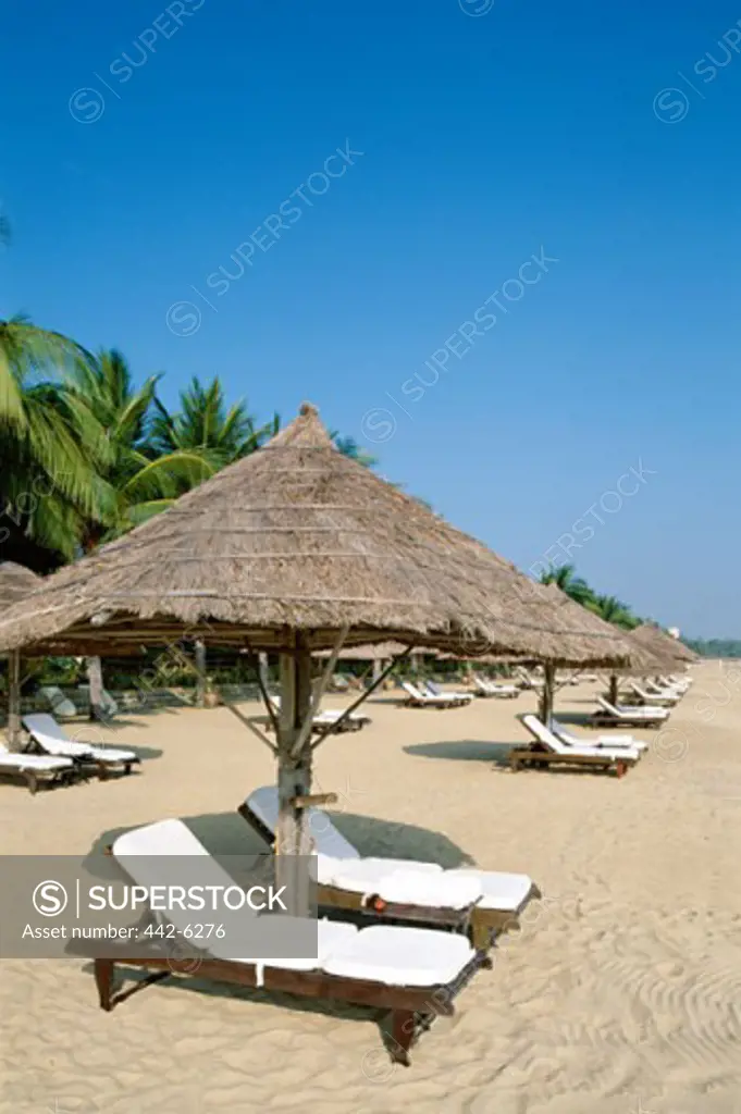 Sunshades and lounge chairs on a beach, Nha Trang Beach, Nha Trang, Vietnam