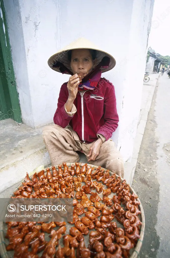 High angle view of a street vendor selling bird whistles, Hoi An, Vietnam