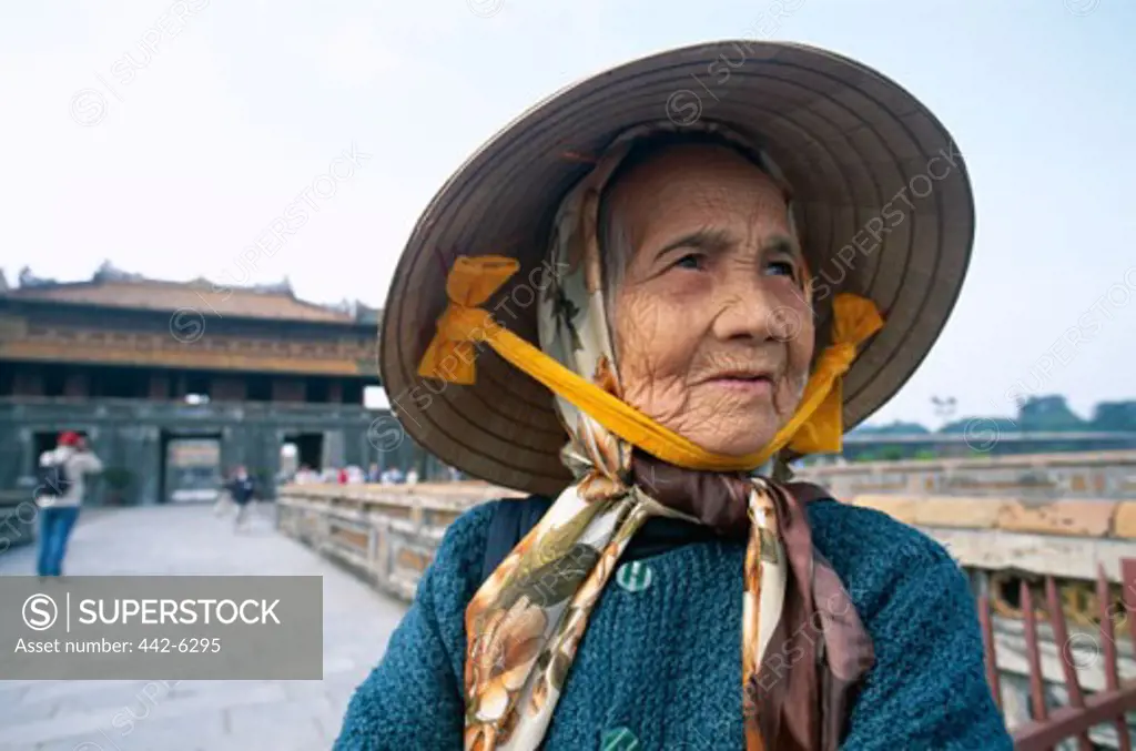 Close-up of a senior woman wearing a traditional conical hat, Ngo Mon Gate, Imperial Palace, Hue, Vietnam