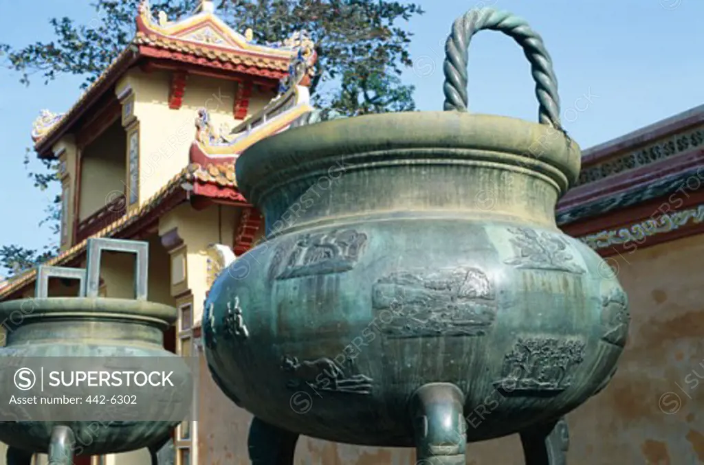 Low angle view of bronze dynastic urns, Imperial Palace, Hue, Vietnam