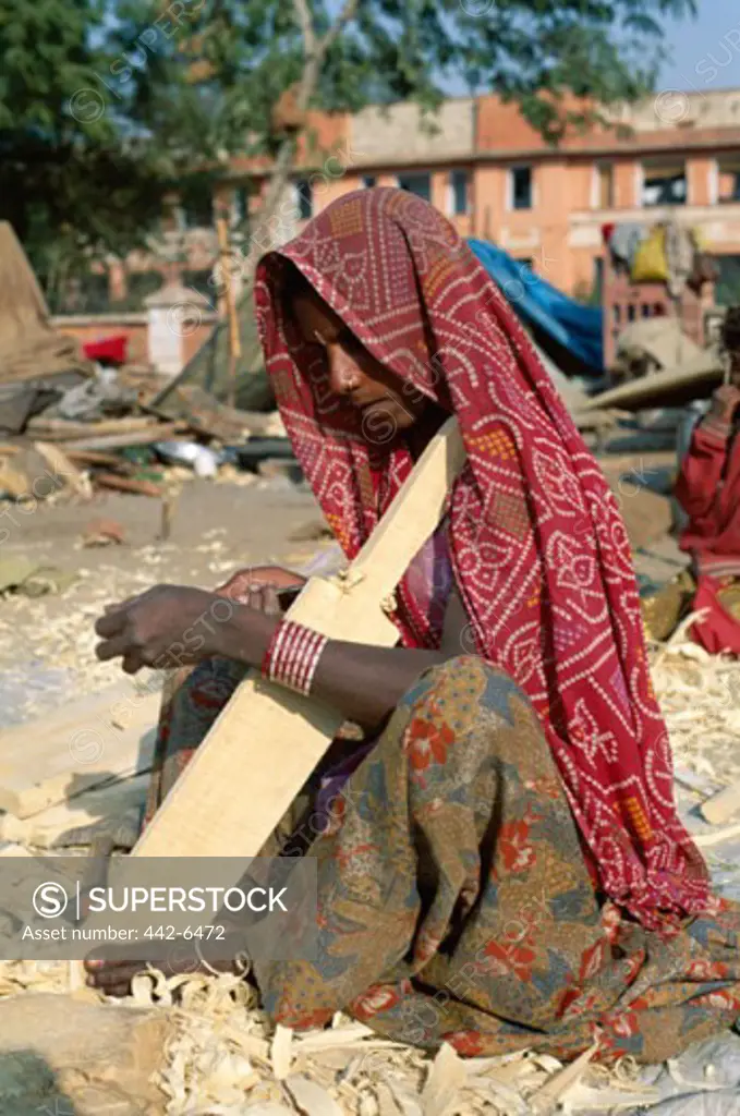 Close-up of a mid-adult woman making a cricket bat, Jaipur, Rajasthan, India