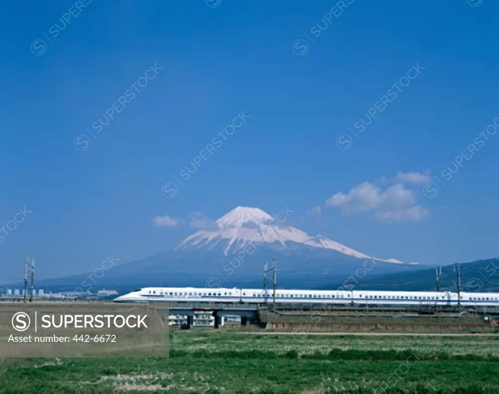 Bullet train passing by a mountain, Mount Fuji, Honshu, Japan