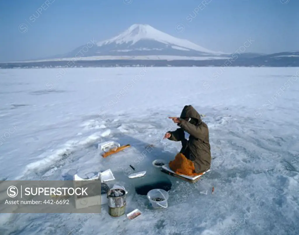 Fishermen fishing on a frozen lake, Lake Yamanaka, Mount Fuji, Honshu, Japan