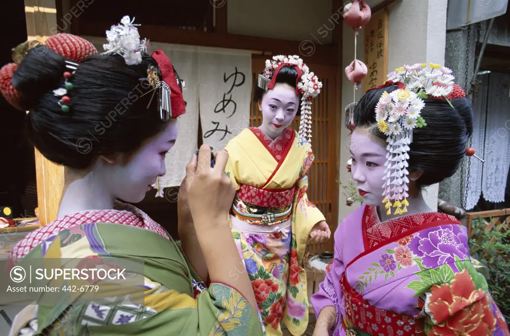 Three geishas (Maiko) dressed in kimonos, Kyoto, Honshu, Japan