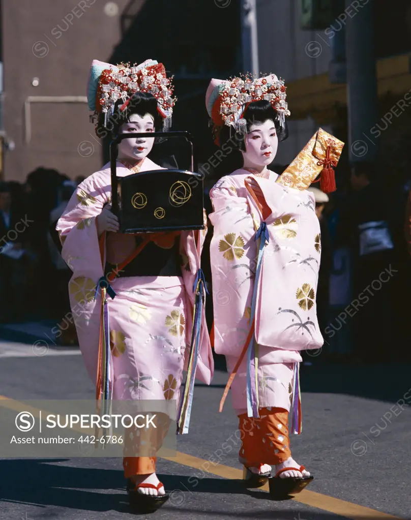 Two geishas (Maiko) dressed in kimonos, Kyoto, Honshu, Japan