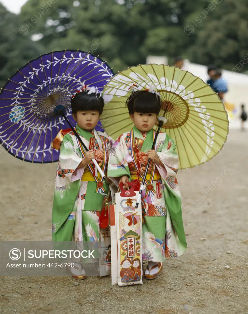 Portrait of two girls at the Shichi-go-san Festival dressed in kimonos, Tokyo, Honshu, Japan