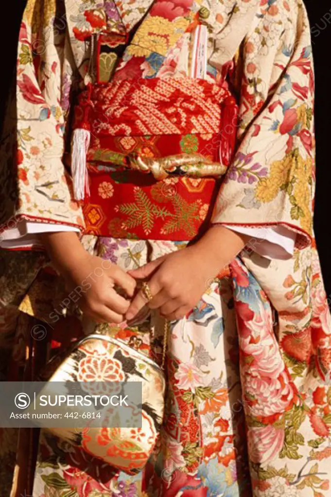 Mid section view of a woman dressed in a kimono, Japan