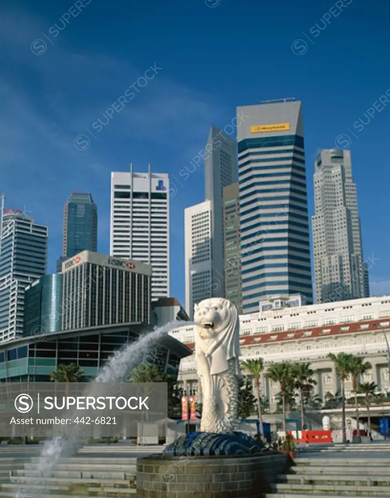Low angle view of the Merlion Statue Fountain and Fullerton Building, Singapore
