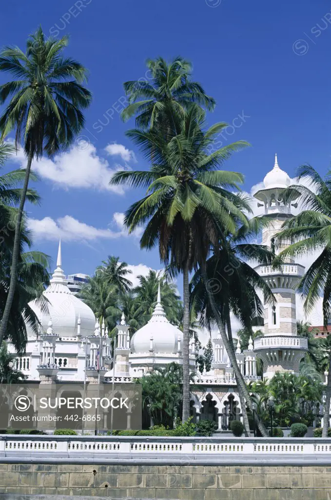 Palm trees in front of the a mosque, Masjid Jame Mosque, Kuala Lumpur, Malaysia