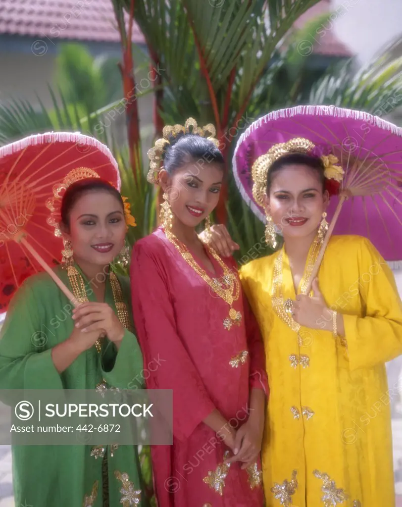 Portrait of three young women dressed in Malay traditional costumes, Kuala Lumpur, Malaysia