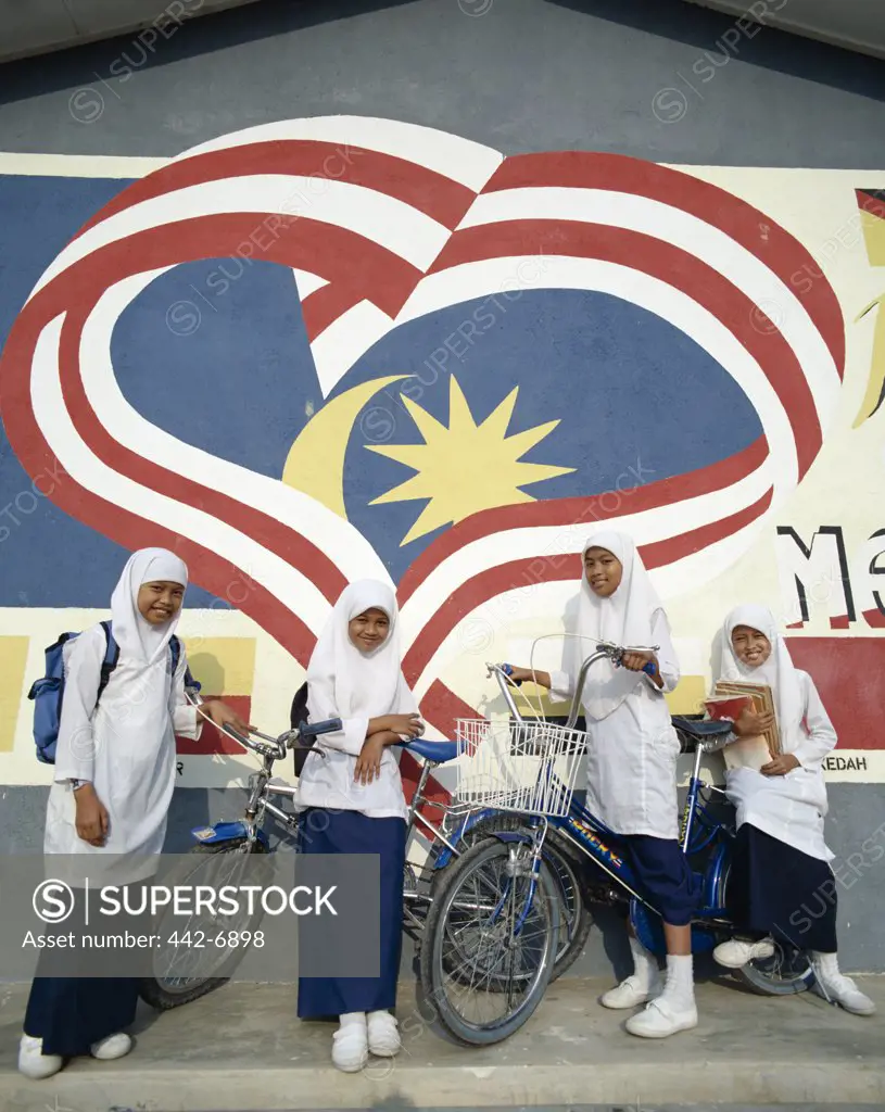 Group of girls in front of a Malaysian flag mural, Kota Bharu, Kelantan, Malaysia