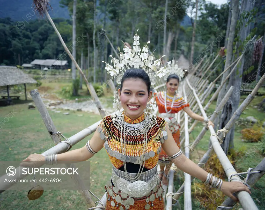 Portrait of two young Iban women dressed in traditional costumes, Sarawak Cultural Village, Sarawak, Malaysia