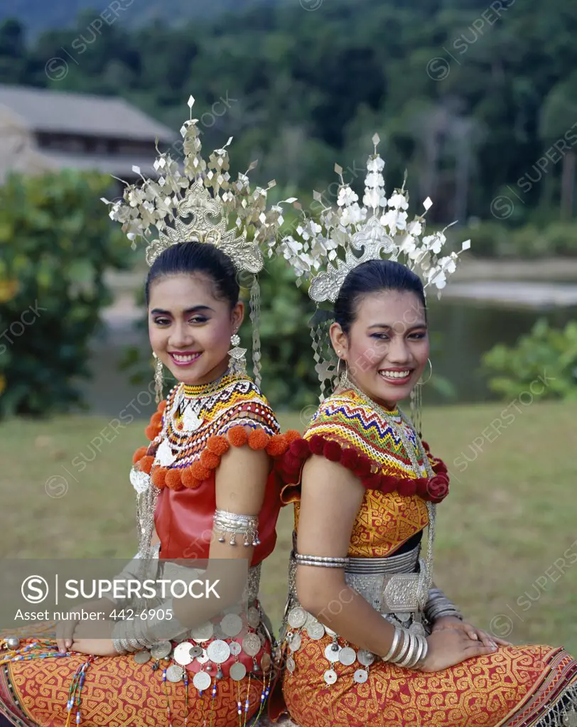 Portrait of two Iban women dressed in traditional costumes, Sarawak Cultural Village, Sarawak, Malaysia