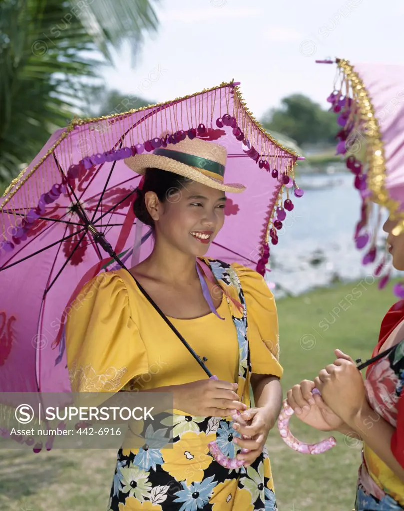 Side profile of two young women dressed in traditional costumes, Manila, Philippines